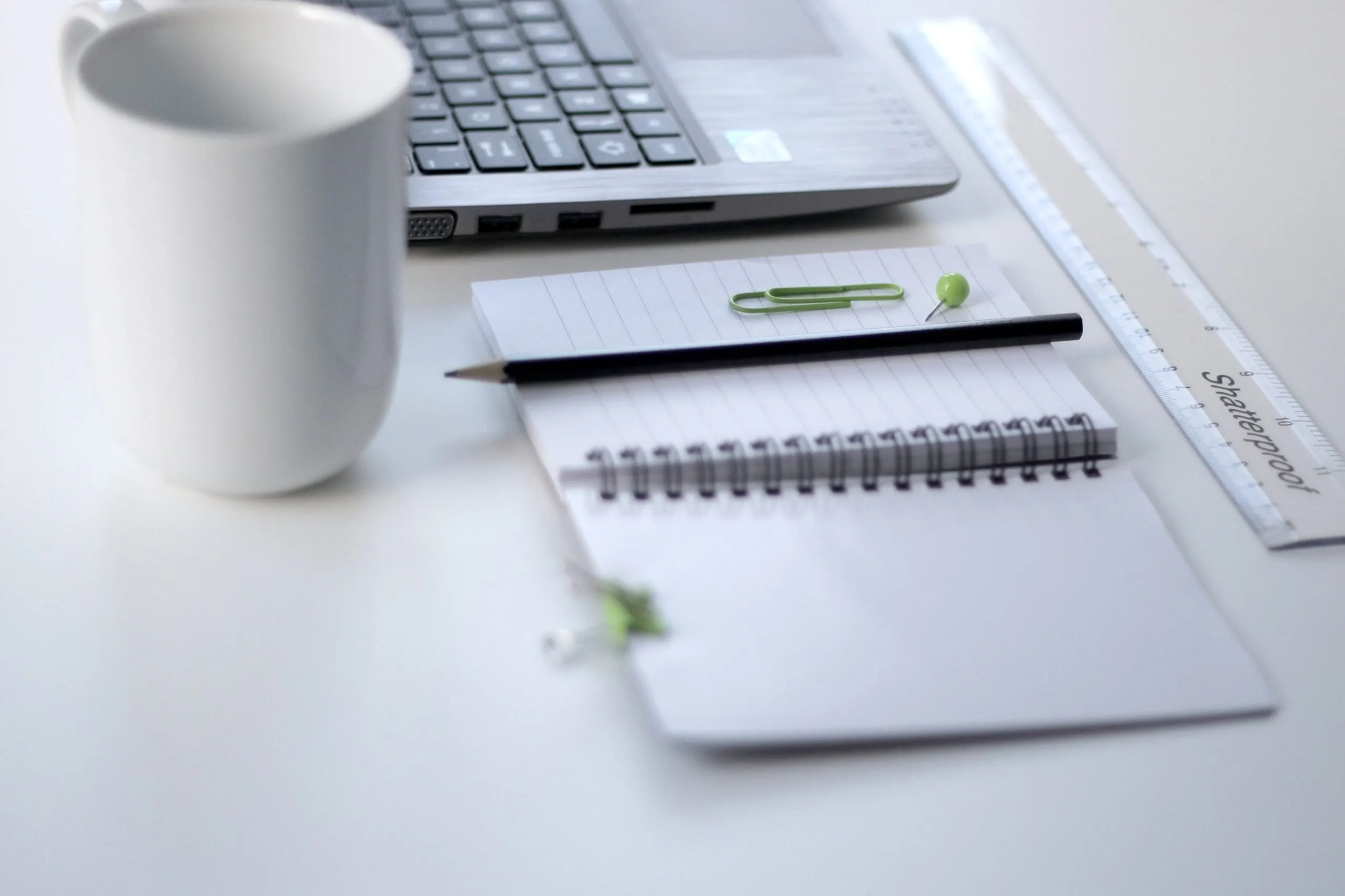 A laptop and ruler on an office desk